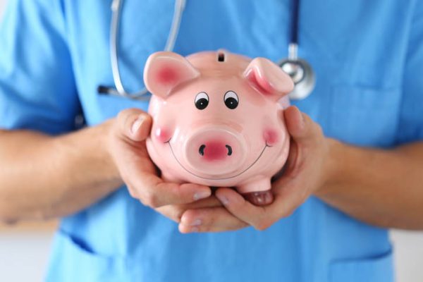 nurses wage increase - holding piggy bank